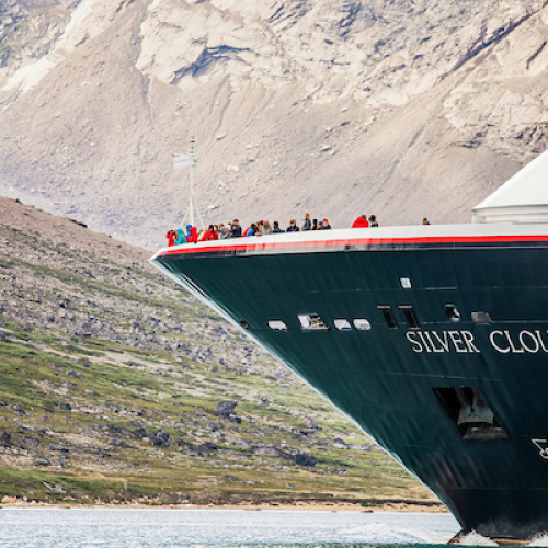 Guests enjoying the landscape from the bow of the Silver Cloud in Greenland.